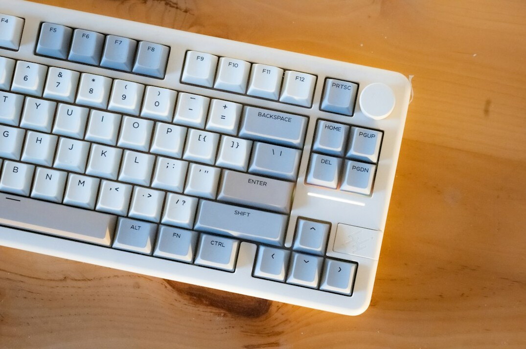 Hands typing on a laptop with analytics on screen